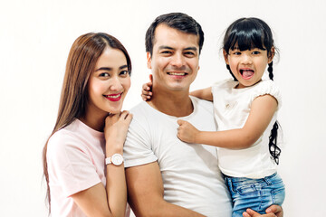 Portrait enjoy happy smiling love asian family father and mother with young parents little child asian girl daughter play ann look at camara in moments good time on wall background