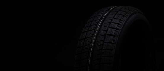 image photograph of a black tire on a black background