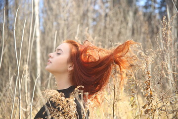 portrait of a young woman with red hair in a field beauty female lady pretty cute face fashion model  forest grass one person girl smiling outdoors