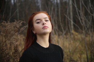 Closeup portrait of a young girl with red hair in forest pretty woman cute one person portrait beauty smile lifestyle