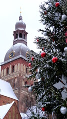 Christmas tree outside the Dome Cathedral in Riga is snowing