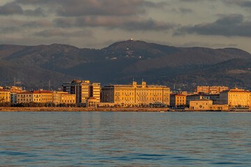 The golden light of sunset on the Mascagni Terrace in Livorno, Italy, seen from the sea
