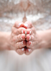 Wedding ring in the hands of the bride