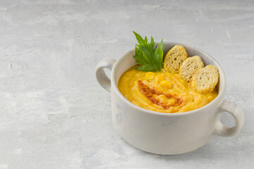 Delicious creamy corn soup on a light background. Food for vegans and vegetarians. Healthy diet. Copy space.