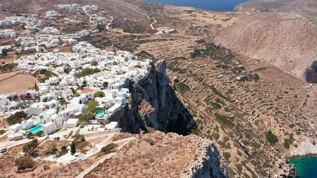 Flying through Beautiful white washed greek city on Cliff edge, Folegandros Island
