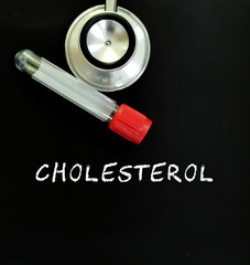 Cholesterol text with stethoscope  and test tube on blackboard. medical concept.