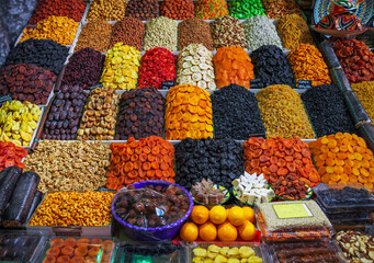 Delicious dried fruits, sweets  and nuts on counter at wholesale market