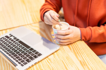 Fototapeta premium Alternative unrecognizable person with a coffee surfing the internet on the computer