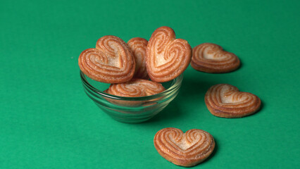 Delicious homemade heart shaped cookie on a color background. Top View. Place for text.