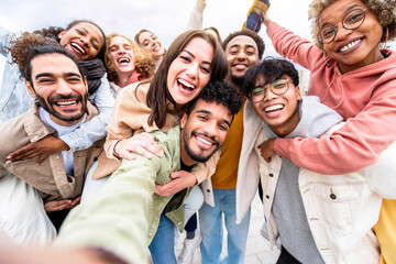 Fototapeta Multiracial friends group taking selfie portrait outside - Happy multi cultural people smiling at camera - Human resources, college students, friendship and community concept obraz