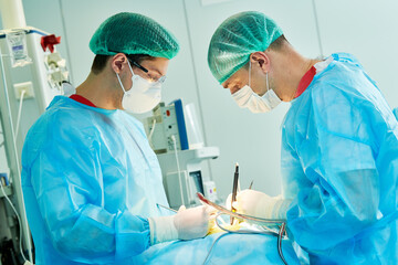 Emergency surgery. Surgeons during surgical intervention in clinic