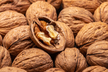 whole and cracked walnuts background