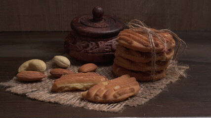 Homemade oatmeal cookies with flax and sesame seeds on white wooden table, copy space. Healthy vegan oat cookies