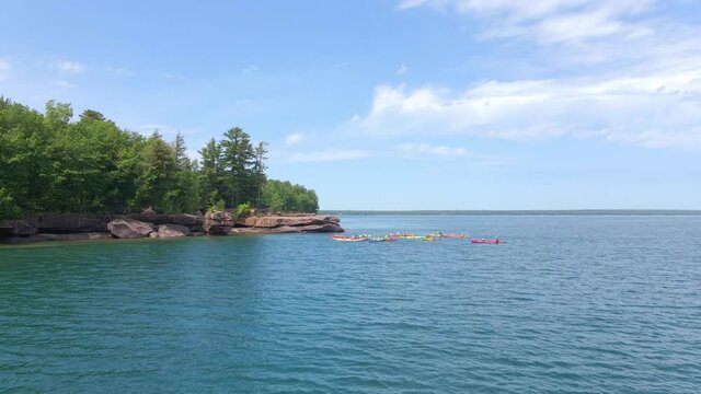 Group of kayakers enjoying the summer outdoors at Madeline Island, Big Bay state park at Apostle island Lake Superior Wisconsin, United States