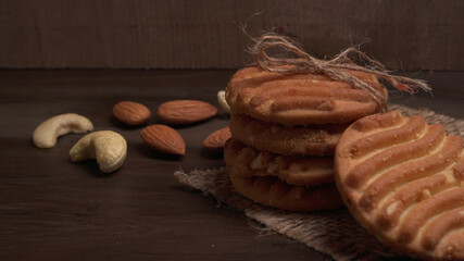 Homemade oatmeal cookies with flax and sesame seeds on white wooden table, copy space. Healthy vegan oat cookies