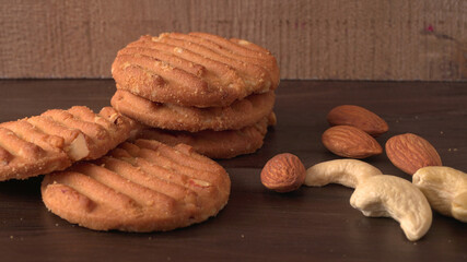 Homemade oatmeal cookies with flax and sesame seeds on white wooden table, copy space. Healthy vegan oat cookies