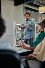 Male coach presenting business plan, strategy or new project on meeting