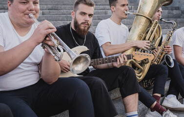 Young street music band play a lot of musical instruments