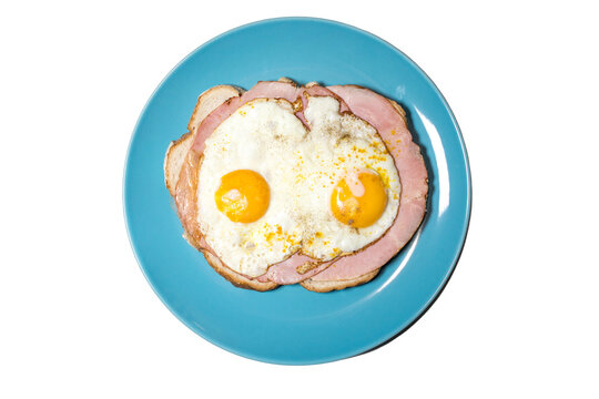 Top view of a meat sandwich with fried egg. Yellow egg yolk.
Dutch lunch Uitsmijter.