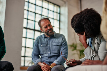 Upset african american woman at group therapy