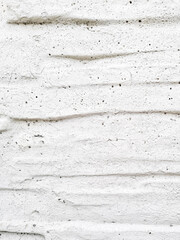 Interesting design of gray textured background from old wall with cracks, scuffs and potholes, vertical arrangement, place for text, close-up