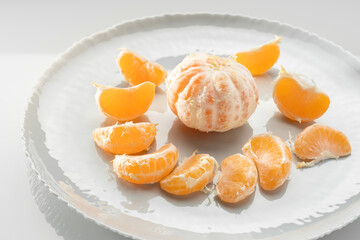Tangerine slices on white plate close-up