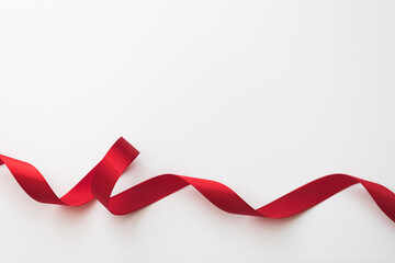 loops of red  ribbon on gray text place .