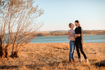 happy couple by the lake at sunset - Image