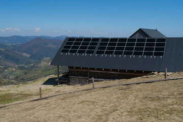 Solar cell panels on roof of house in mountains