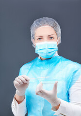 a nurse in a protective suit and a mask protects herself from viruses
