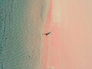 Enjoying the calming sea on the top of pink sands at Long Pink Beach