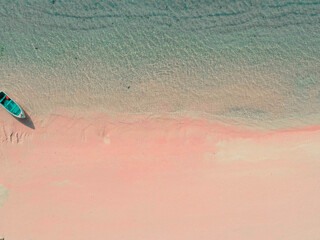 A small boat on the pink beach of Labuan Bajo