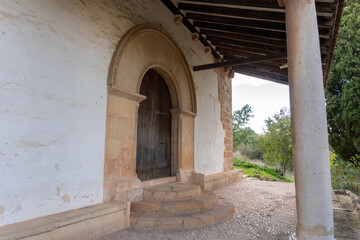 Large wooden door with a sculpted stone portico, at the entrance to Sant Feliu church in Xativa