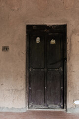 Ancient indian vintage closed wooden door in Mangalore, India.