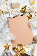  golden christmas decorations and notebook on white background. Flat lay, top view, copy space - Image