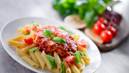 Composition with a plate of pasta penne rigate