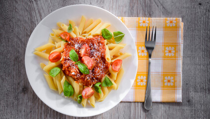 Composition with a plate of pasta penne rigate