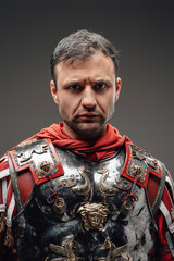 Roman centurion wearing steel armor against dark background