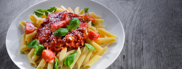 Composition with a plate of pasta penne rigate