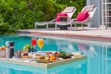 Breakfast in swimming pool floating. Luxury summer vacation or honeymoon destination. Resort hotel...