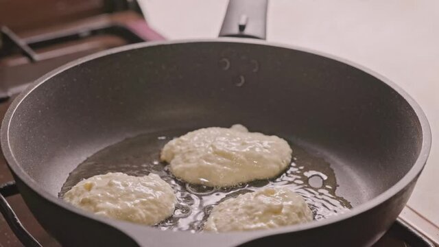 semi-liquid dough roasting on cast iron pan covered with vegetable oil