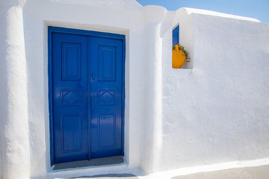 Beautiful details of the island of Santorini, white houses, blue doors and shutters, scenic views of the Aegean Sea. Summer travel landscape, rural view. Idyllic vacation destination, holiday pictures