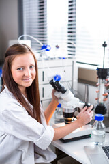 Portrait of a female chemistry student carrying out research in a chemistry lab (color toned image; shallow DOF)