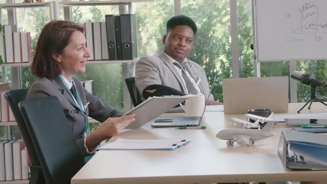 Airline business air hostess and captain aviator in uniform meeting discussion on flight business and training service of stewardess to understand yearly income and promotion
