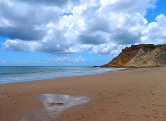 Cloudy Burgau beach in the Algarve region of Portugal