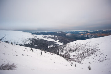 Panorama of snow-capped mountains, snow and clouds on the horizon