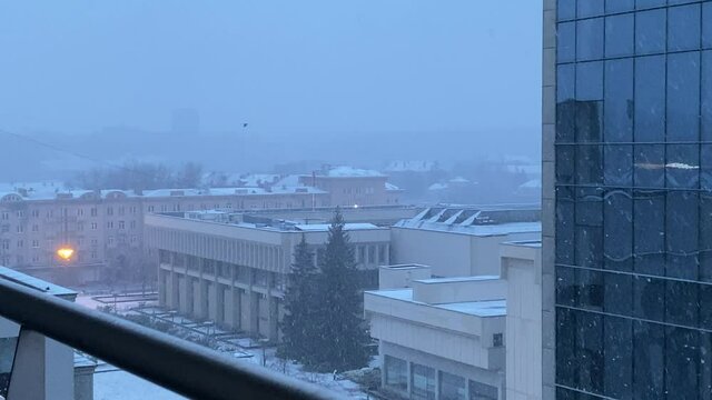 Snowfall in Vilnius city center in early morning, view from above