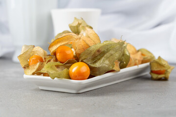 Physalis in a white dish.