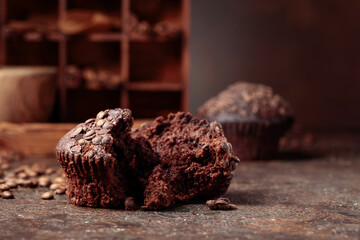 Chocolate muffins on a brown background.