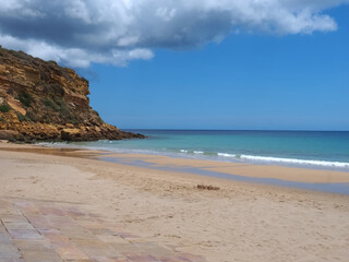 Cloudy Burgau beach in the Algarve region of Portugal